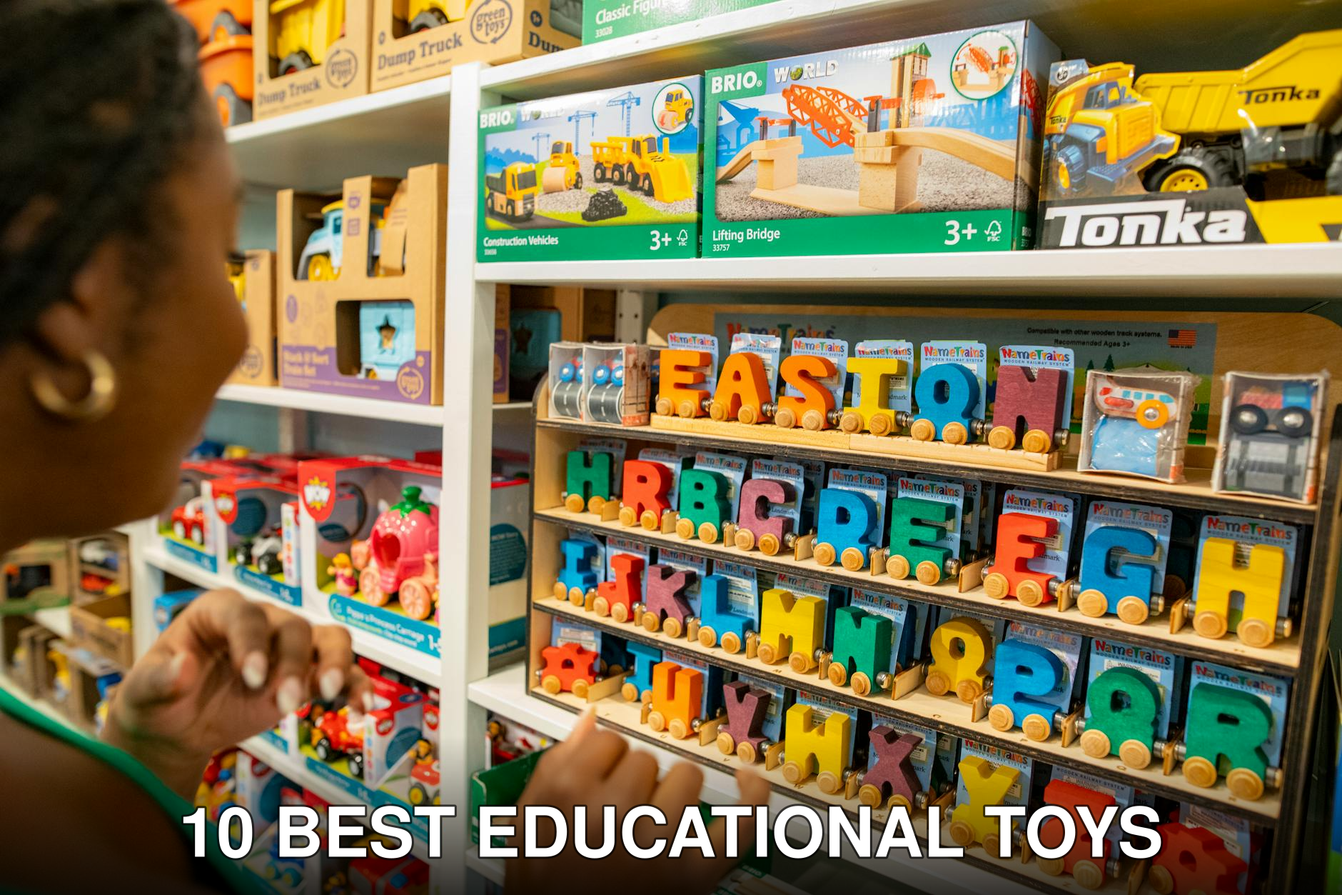 Woman explores colorful educational toys and alphabet blocks in a bustling toy store.