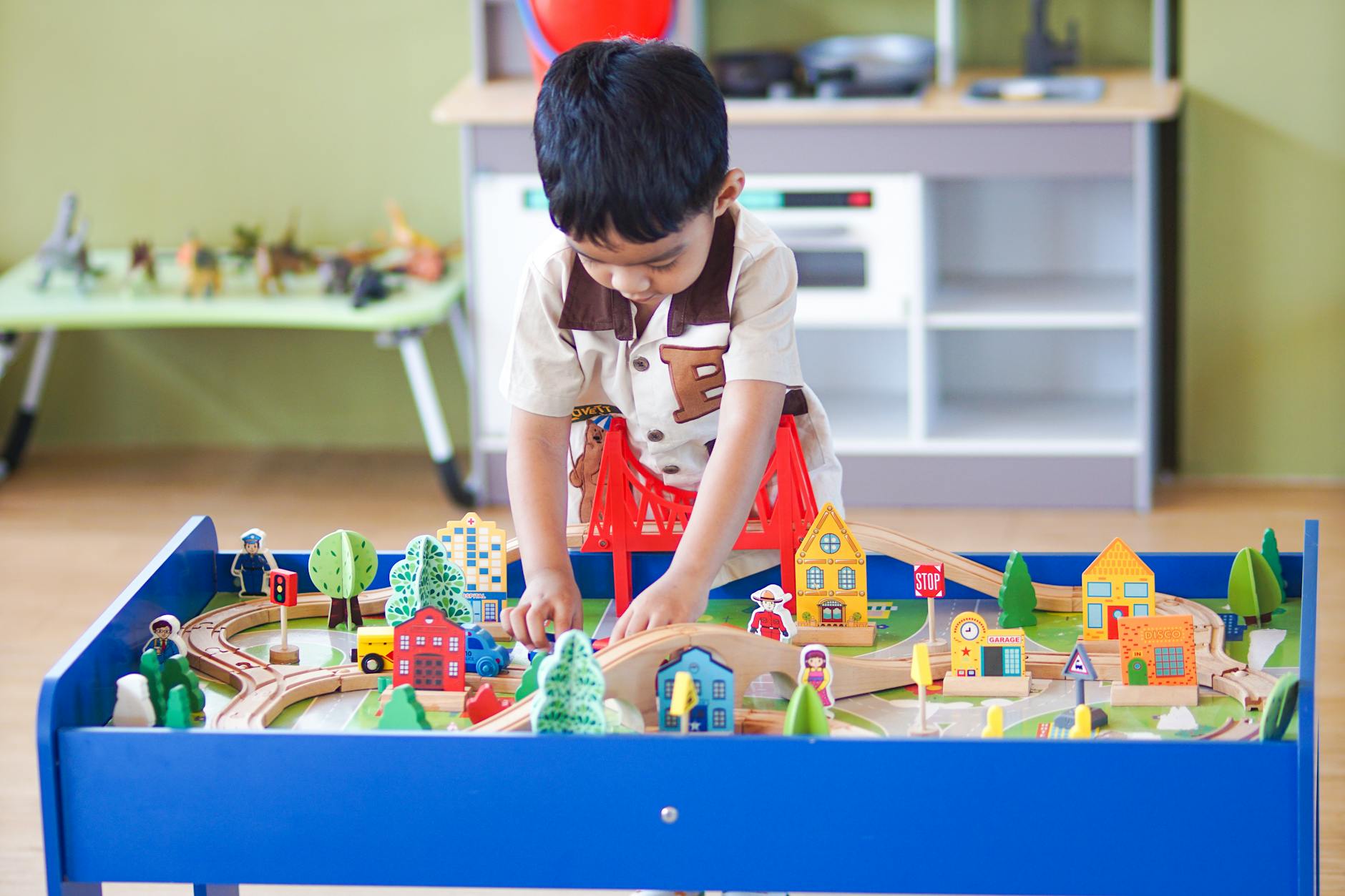 Young boy playing with a colorful wooden toy set, enhancing creativity and learning indoors.