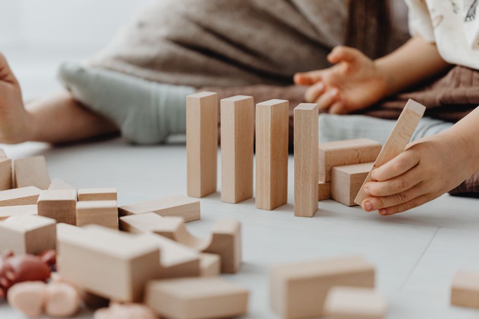 Young child engaging with wooden blocks, encouraging creativity and fine motor skills.