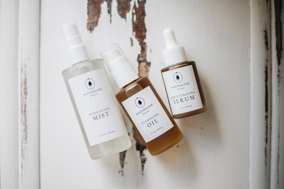 Elegant flatlay of natural skincare products on rustic wood background.