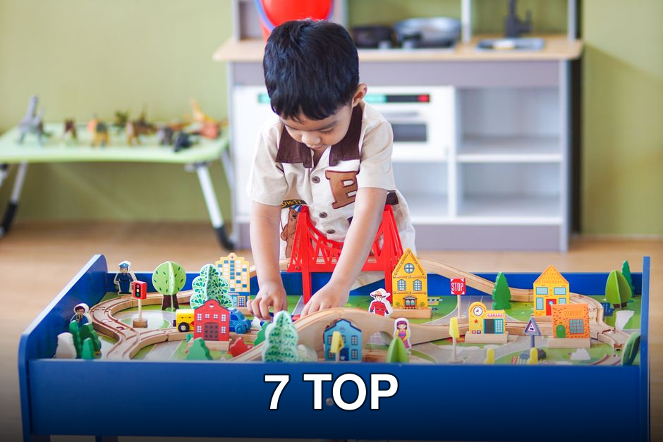 Young boy playing with a colorful wooden toy set, enhancing creativity and learning indoors.