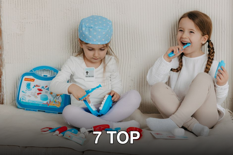 Two young girls having fun playing dentist with a toy kit indoors, enjoying imaginative play.