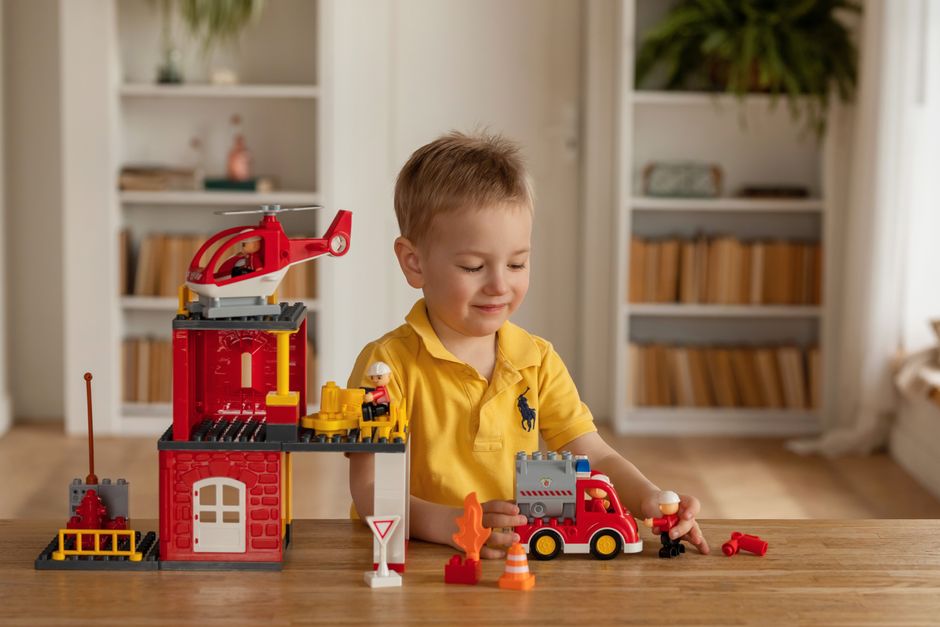 Young boy playing with colorful building blocks in a cozy living room.