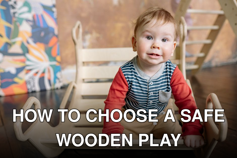 Cute toddler with blond hair plays indoors on a wooden toy, wearing colorful clothing, smiling at the camera.