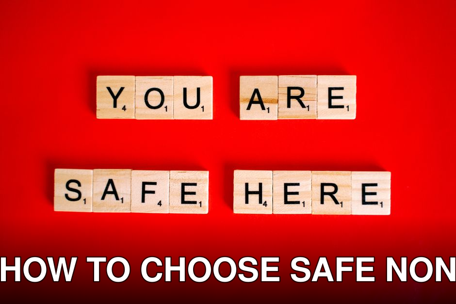 Wooden Scrabble tiles display 'You Are Safe Here' against a red background, symbolizing safety.
