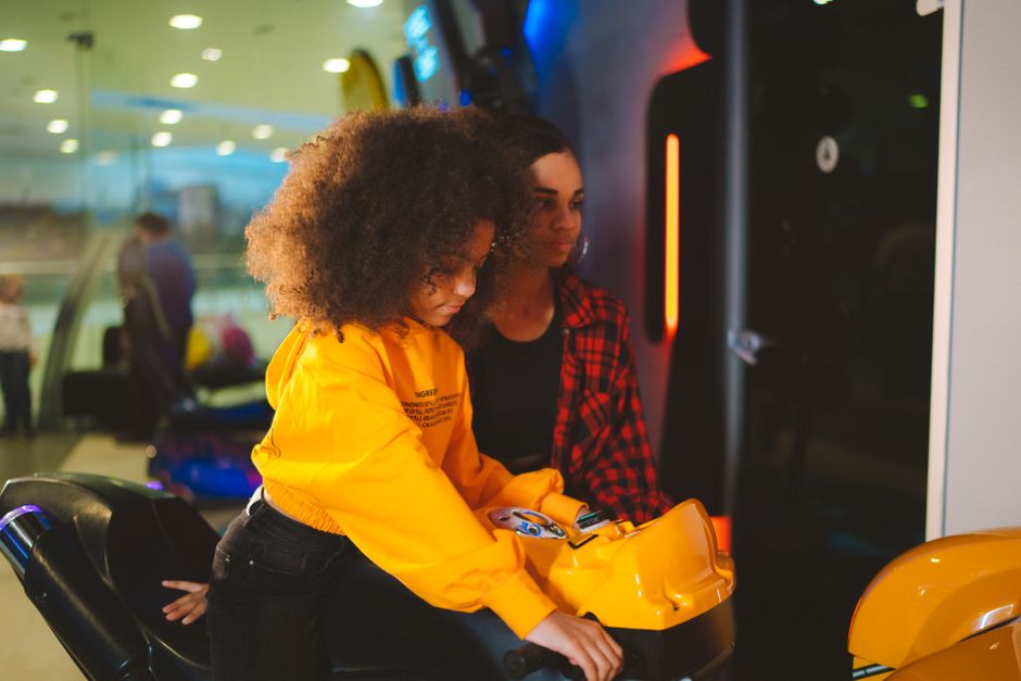Young girl enjoying a fun arcade game indoors, captured with a modern style.