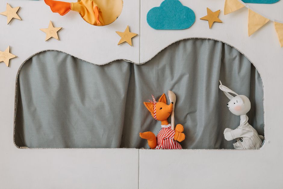 A whimsical puppet show featuring colorful fabric puppets on a playful stage.