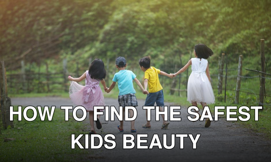 Four children joyfully walk hand in hand along a scenic country road.