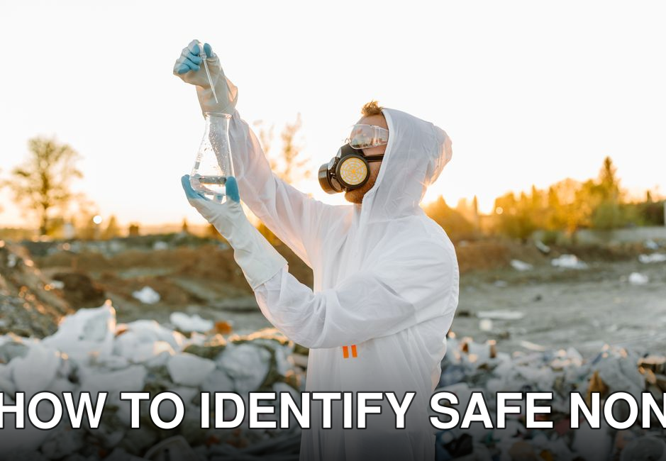 Scientist in protective gear collecting samples at a waste site during sunset.