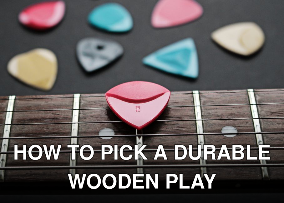 Close-up of a fretboard with colorful guitar picks showcasing musical inspiration.