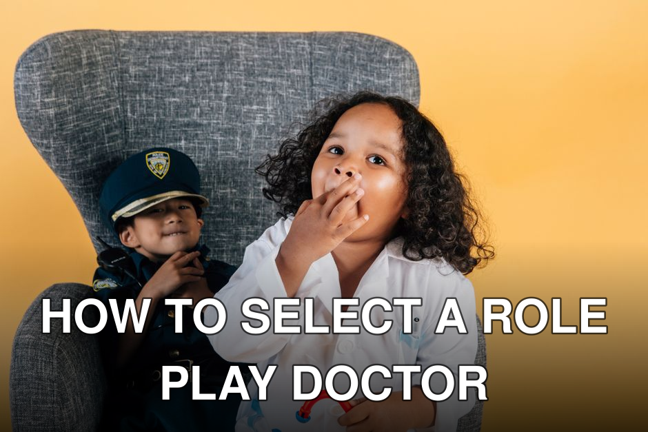 Asian boy in policeman costume and curly African American girl in doctor uniform sitting in armchair together while playing in studio on yellow background