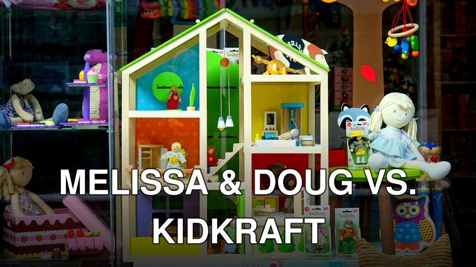 A vibrant dollhouse and stuffed toys displayed in a toy store window, perfect for children's play.