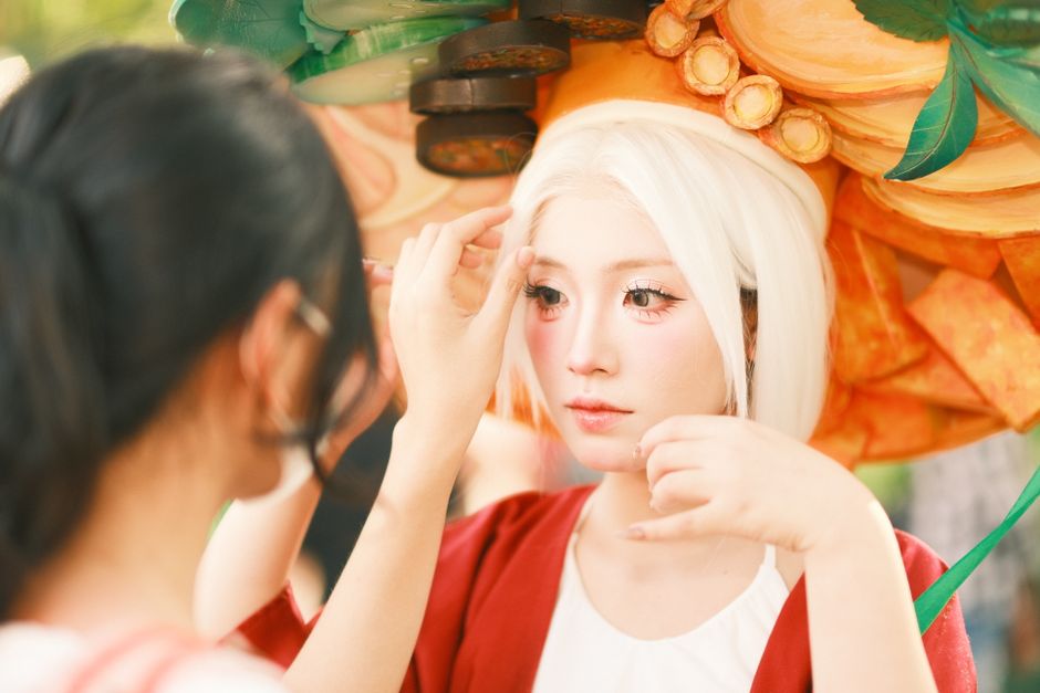 A cosplayer gets final touches applied to her makeup before an event in Vietnam.