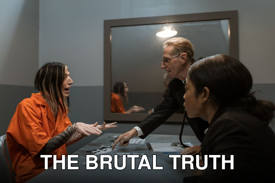 A high-intensity scene in an interrogation room with a detective questioning a handcuffed suspect.