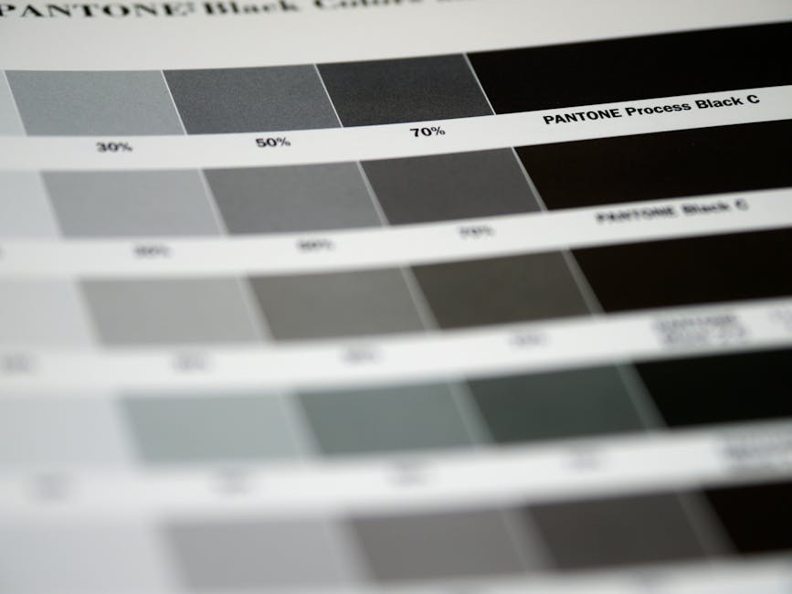 Detailed close-up of Pantone black color swatches, featuring various shades and percentages.