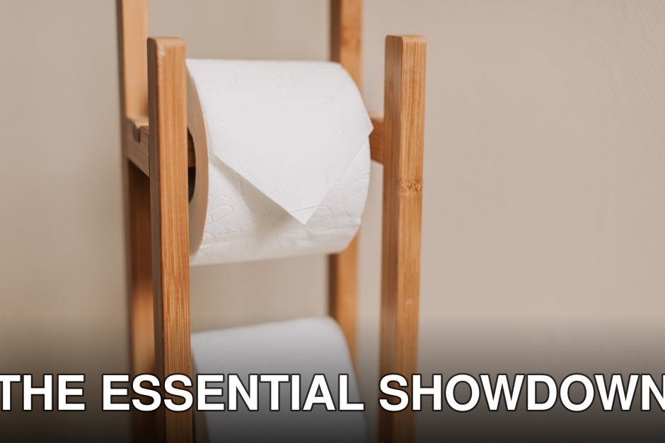 Wooden rack holding two toilet paper rolls in a minimalistic bathroom setting.