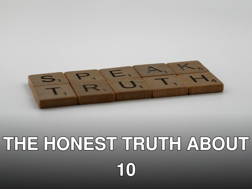 Wooden Scrabble tiles forming the phrase 'Speak Truth' on a white surface.