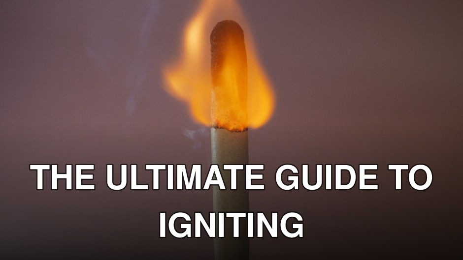 A close-up photograph of a matchstick burning brightly with visible flame.