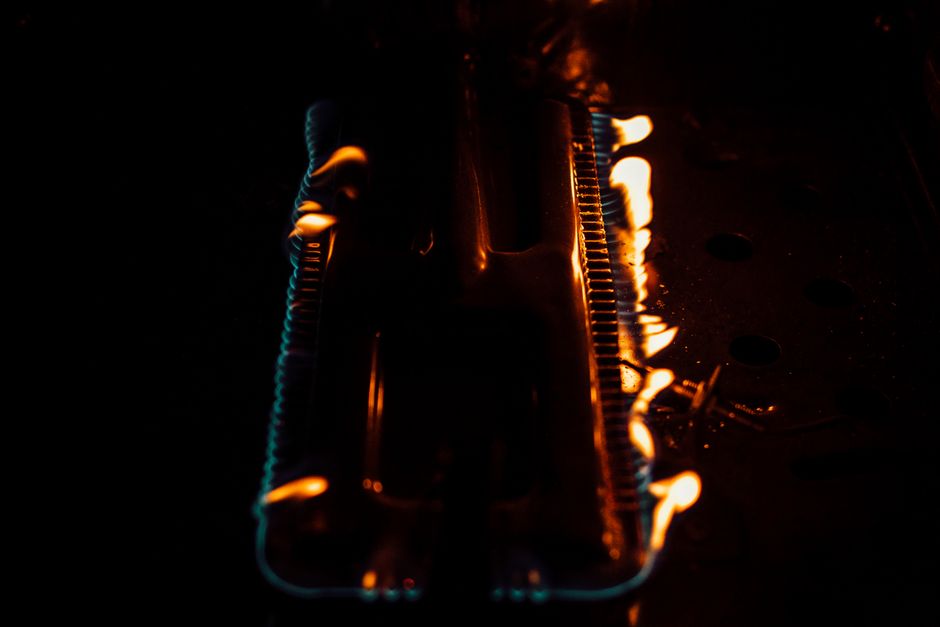 Close-up of flames on a gas burner. Dark and intense atmosphere with glowing fire.