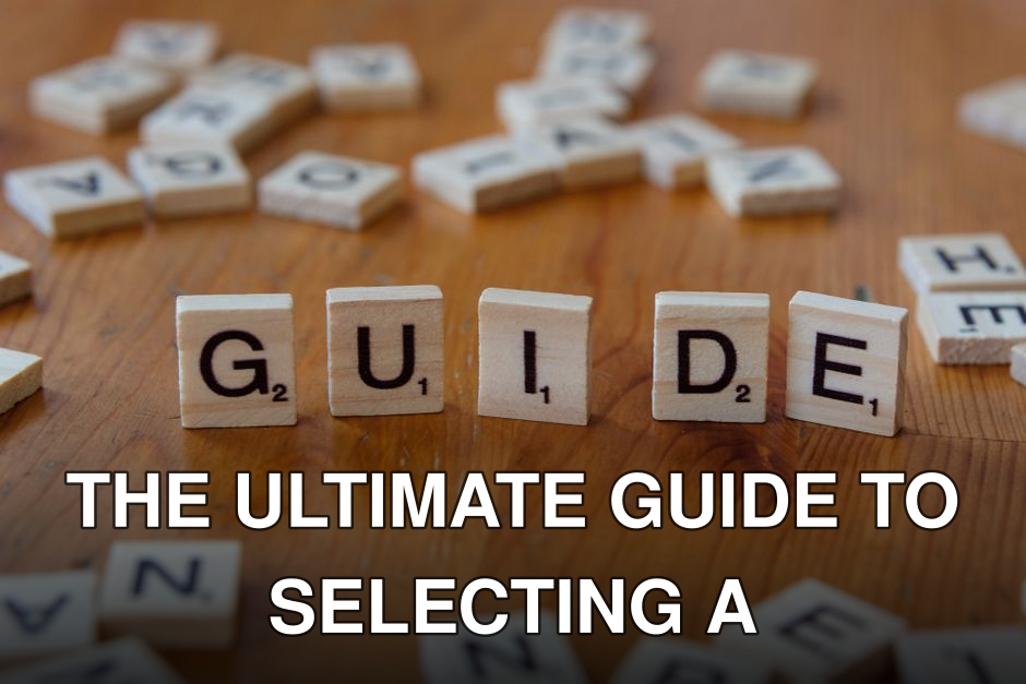 Scrabble tiles forming the word 'Guide' surrounded by scattered letters on a wooden table.