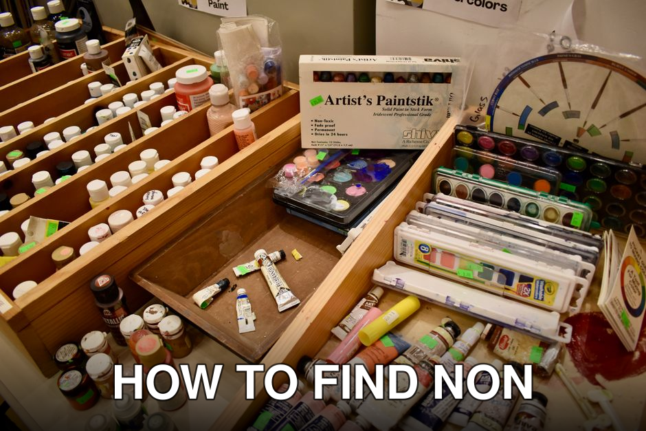 A variety of art supplies at a creative reuse center in Norfolk, Virginia, showcasing paints and other materials.