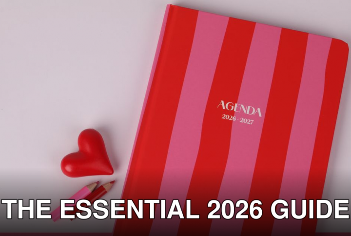 Colorful agenda with red and pink stripes, heart, and pencils on a flat lay.