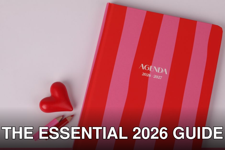 Colorful agenda with red and pink stripes, heart, and pencils on a flat lay.