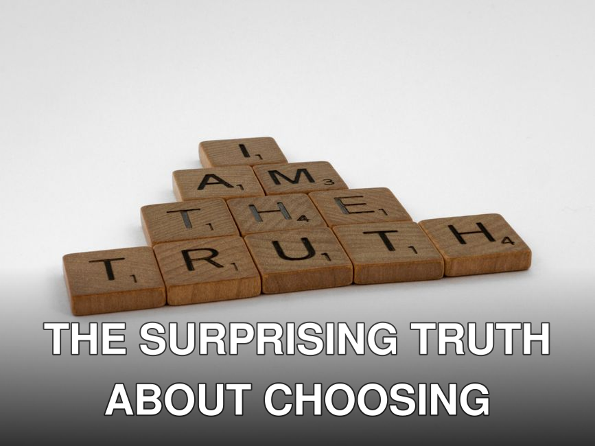 Close-up of wooden Scrabble tiles on a white background spelling 'I Am The Truth'.