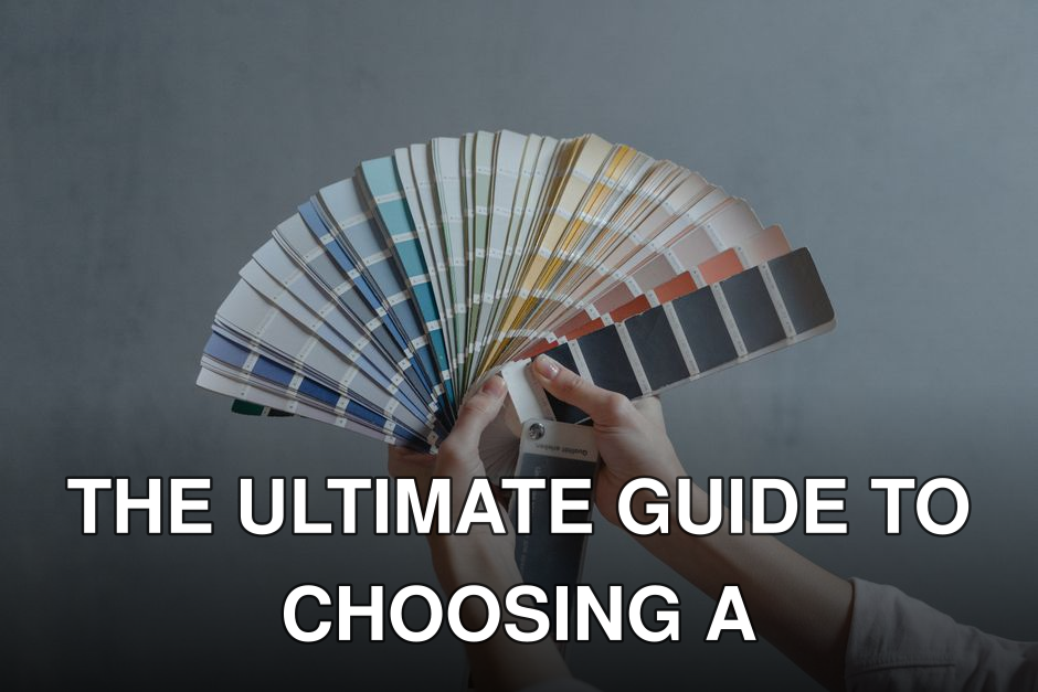 Hands holding a colorful fan of swatches on a gray backdrop, ideal for design themes.