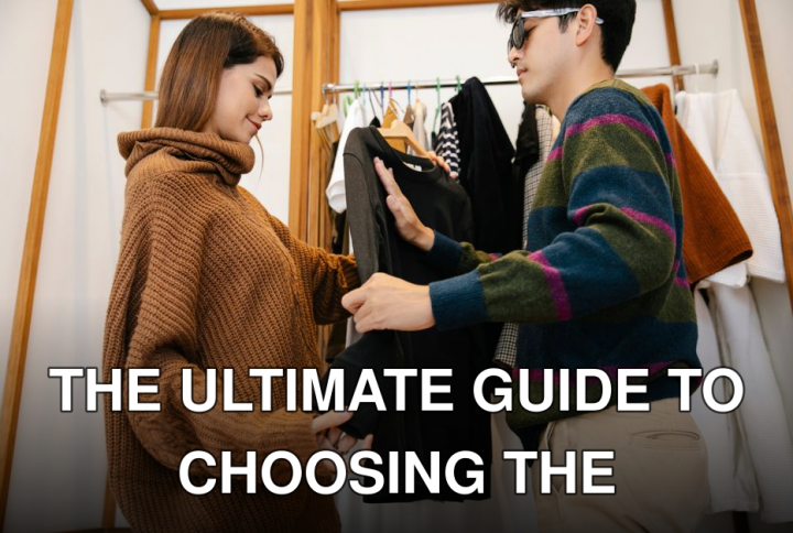 A man with visual impairment exploring clothes with a woman's help in a store.