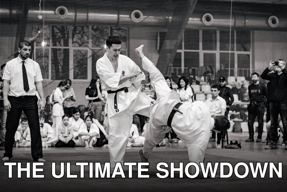 Black and white action shot of a karate match at a tournament, showcasing skillful combat.